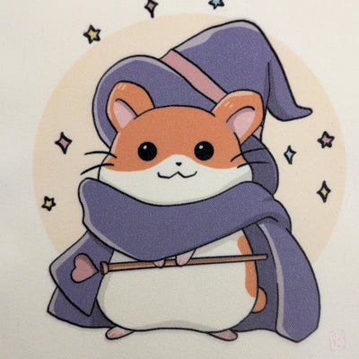 Cute kawaii image framed wizard hamster tote bag with pastel fantasy artwork featuring a magical hamster holding a wand and spell book. Reusable 14 x 16 inch canvas polyester shoulder bag for shopping, school, and everyday use.
