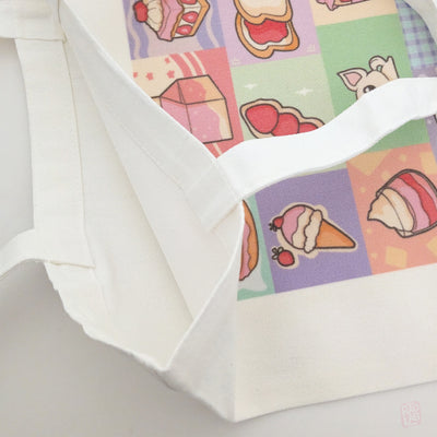 Close up of cute pastel dessert-themed tote bag featuring original Radlab characters surrounded by cakes, macarons, ice cream, pastries, and café-inspired artwork. Reusable 14 x 16 inch canvas polyester tote bag for shopping, school, conventions, and everyday use.
