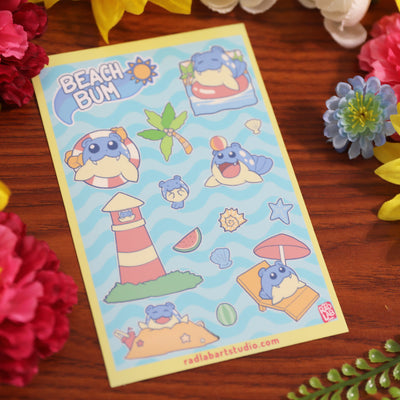 Sticker sheet with Pokemon and beach-themed designs on a wooden surface with flowers.